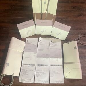 Apple AirPods Generation 2 Pro with receipts, bags, and charger